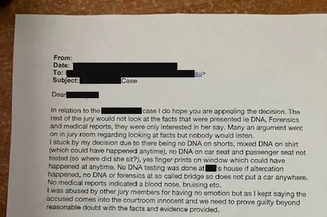 A printed email from a juror, photographed on a table, with the sender, recipient, date and names blacked out. The visible text urges the lawyer to appeal, saying the rest of the jury would not look at the DNA, forensic and medical evidence.