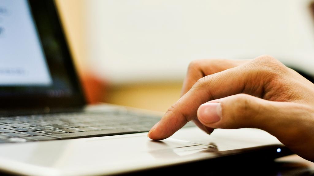 A finger resting on a laptop trackpad. Picture: iStock
