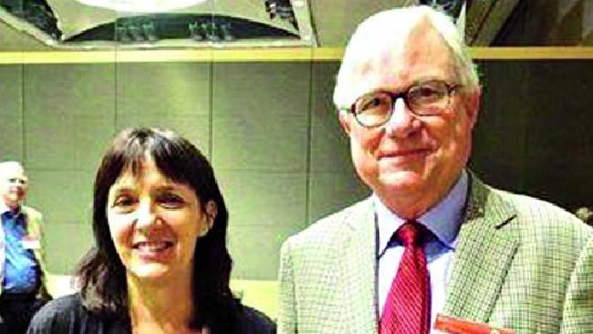 Cathy Kezelman standing beside Justice Peter McClellan at an indoor function, both smiling at the camera.